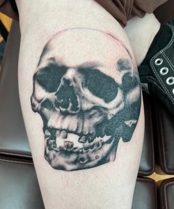 Black laughing skull tattoo – Tim