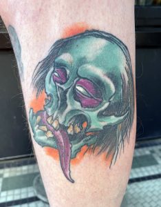 Skull tongue out tattoo –Tim